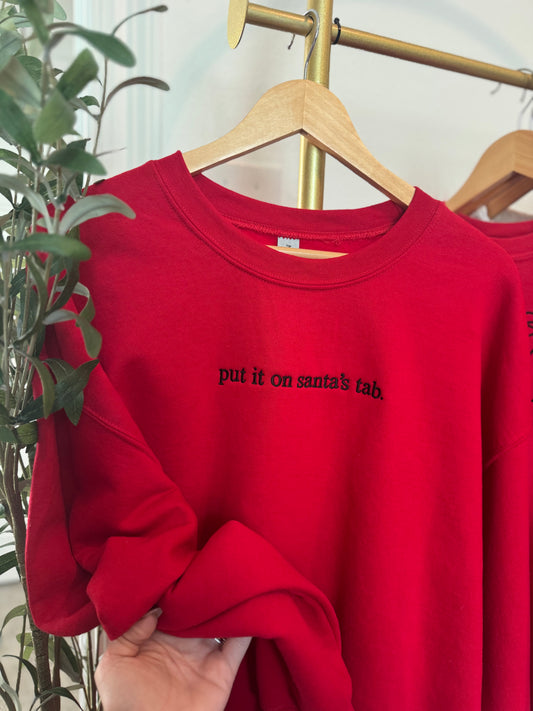 Put it on Santa’s tab. Crewneck Sweatshirt